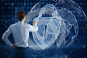 Back view of business man using abstract glowing padlock and globe hologram on blurry blue background. Global web safety and