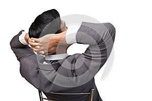 back view of business man wearing gray suit sitting and relaxing