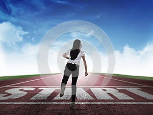 Back view of business woman running from start line