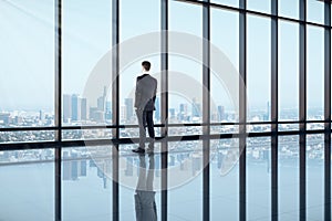 Back view of businessman looking out of window