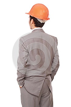 Back view of businessman in orange builder's helmet