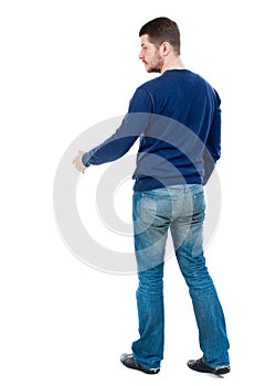 Back view of businessman reaches out to shake hands.