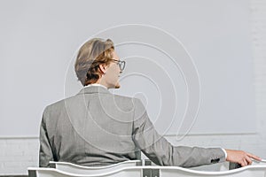 back view of businessman sitting on chair