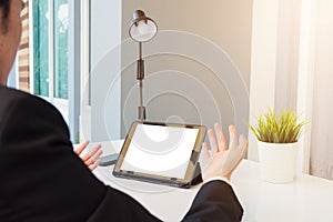 Back view of Businessman video conference by tablet