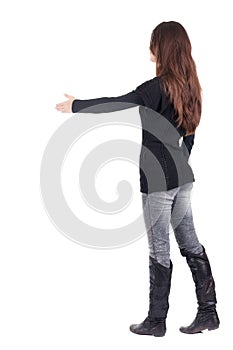 Back view of businesswoman reaches out to shake hands.