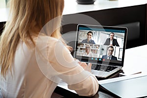 Female employee have team web conference on laptop photo