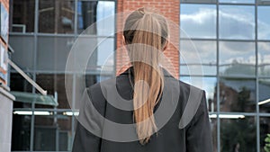 Back View of Businesswoman Walking Ouside Office