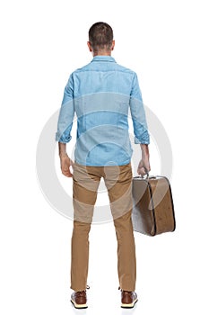 Back view of casual man in his forties taking the luggage and leaving town for a work conference