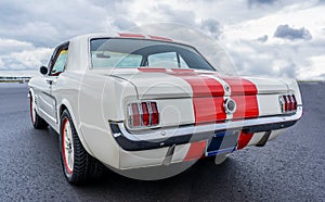 Back view of a classic Ford Mustang 1965 on display at a classic car meeting