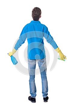 Back view of a cleaner man in gloves with sponge and detergent.