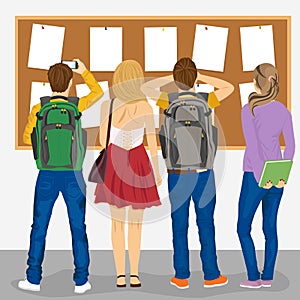 Back view of college students looking at bulletin board