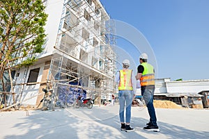 back view construction Engineer, architect working together at construction site. construction worker planning at construction