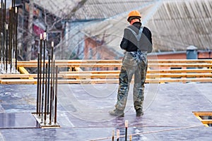 Back view construction site worker in helmet