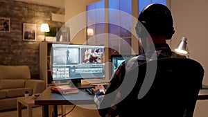 Back view of content creator working in home office