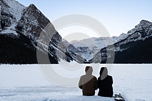 Back view of a couple admiring the Lake Louise, Canada