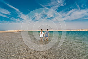 Back view of couple posing at lake in desert of Ras Mohammed National Park. Egypt