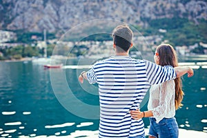 Back view of a couple of tourists sightseeing in a travel destination