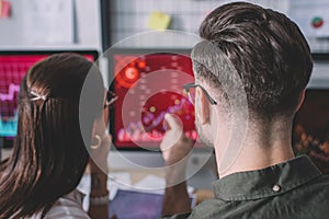 Back view of data analysts working on protection of computer systems