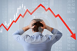 Back view of desperate man losing money in stock market crash photo