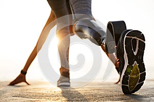 Back view of disabled athlete woman with prosthetic leg