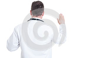 Back view of doctor swearing or having the Hippocratic oath