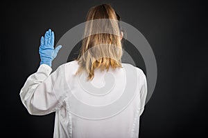 Back view of doctor wearing robe taking Hippocratic oath