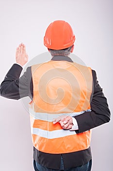 Back view of engineer making fake oath gesture