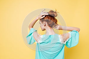 Back view of Enigmatic ginger woman in dress posing