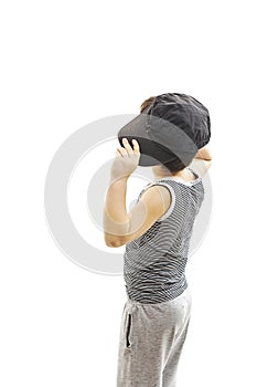 Back view of fashionable little boy.Hip-Hop Style looking at wall.