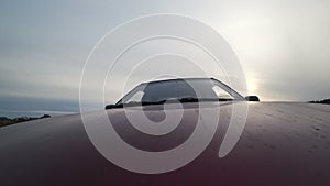 Back view of fast car moving on a evening countryside, nature, rural road, car on high speed