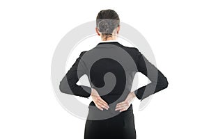 Back view of female holding her spine like hurting