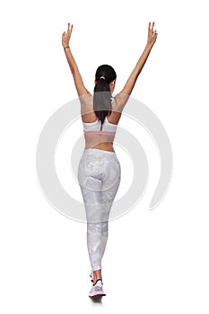 Back view of fit woman walking while making peace sign