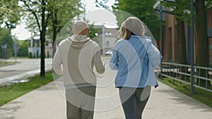 Back view of the fitness, active and healthy mature couple running together on the street. Family enjoying her morning