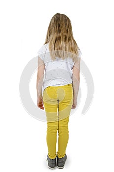 Back view. Full length of adorable teenage girl standing looking down.