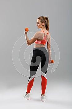 Back view full length portrait of a motivated pretty sportsgirl