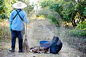 Sweep dry leaves to make compost. Environment protection