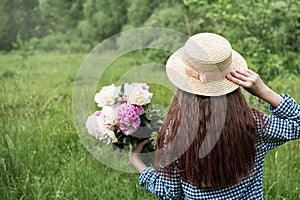 Back view beautiful girl with peonies