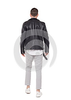 Back view of going handsome man in a leather jacket and trouser photo