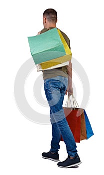 Back view of going man with shopping bags