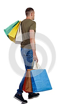 Back view of going man with shopping bags