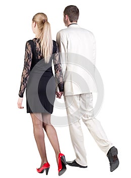 Back view of going young business couple