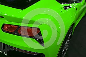 The back view of a green luxury sport car. Exhaust system. Modern Sport Car exterior details. Car detailing