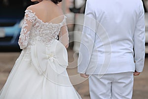 Back view of groom and bride waiting guest in wedding ceremony. Couple love and romance concept.