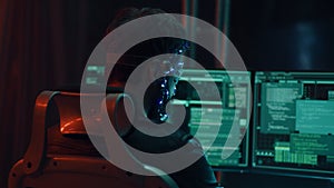 Back view of guy using futuristic headset with LED lights programs develops code