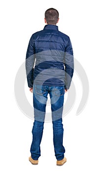 Back view of handsome man in blue windcheater looking.