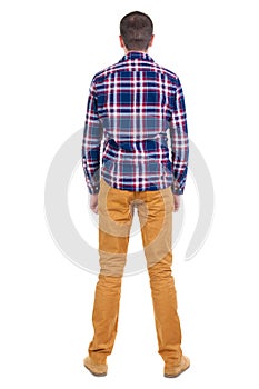 Back view of handsome man in checkered shirt looking up.