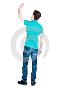 Back view of handsome man greeting waving from his hands.