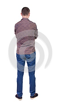 Back view of handsome man in shirt looking up.