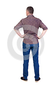 Back view of handsome man in shirt looking up.