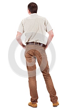 Back view of handsome man in shirt looking up.